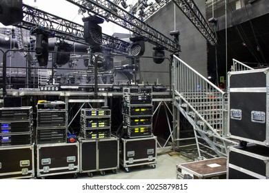 Installation of professional sound, light, video and stage equipment for a concert. Backstage area and tech zone with amplifiers, flight cases and radio microphones.