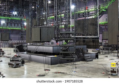 Installation Of Professional Stage, Sound, Light And Video Equipment For A Tv Show. Led Screens. Stage Lighting Equipment Is Clamped On A Trusses. Line Array Speakers. Flight Cases.