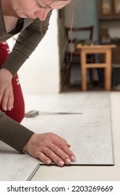 Installation Of Quartz Vinyl Floor, Female Master Installs The Floor, Quartz Floor Of Vinyl Material.