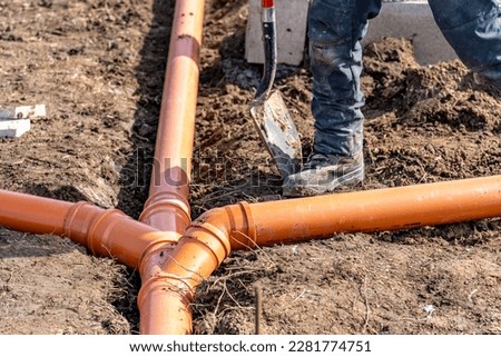 installation of a sewage plastic pipe during the construction of a house