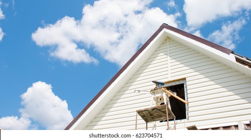 Installation Of A Siding On A House Against The Sky