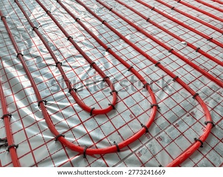 Installation of underfloor heating system in building, above view