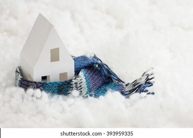 Installation With Winter Background With A House Wrapped In Warm Scarf