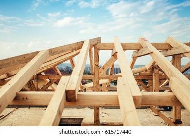 Installation Of Wooden Beams And Timber At Construction Site. Building The Roof Truss System Structure Of New Residential House