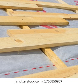 Installation Of Wooden Rafters During The Construction Of The Roof Frame, A Waterproofing Film Is Stretched On Top