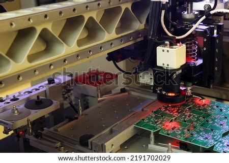 Installer of SMD parts on boards and soldering parts. Machine for automatic assembly and soldering of electronic circuit boards. Electrical soldering parts. Automated device assembly machine.