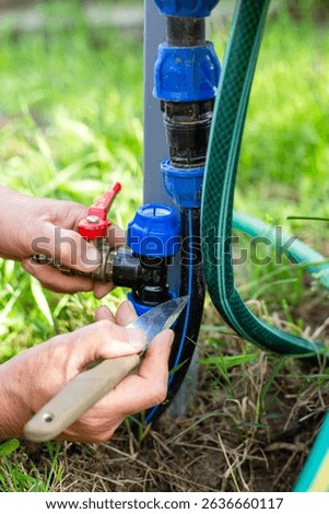 Installing an additional tap for draining drip irrigation. Fitting the tap for insertion into the pipe.