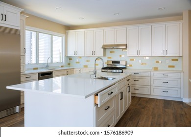 Installing Cabinets And Counter Top In A White Kitchen Partially Installed Furniture.