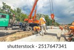 Installing concrete plates by crane at road construction site timelapse hyperlapse. Industrial workers with hardhats and uniform. Reconstruction of tram tracks in the city street