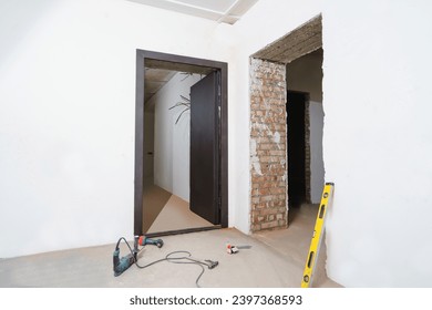 Installing a door at a construction site in an empty room.