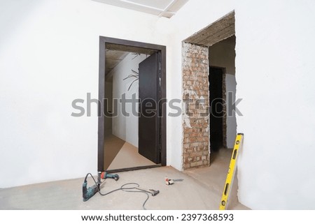 Installing a door at a construction site in an empty room.