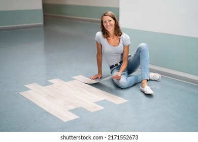 Installing New Vinyl Laminate. Woman Fixing Floor. DIY Project