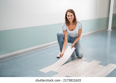 Installing New Vinyl Laminate. Woman Fixing Floor. DIY Project