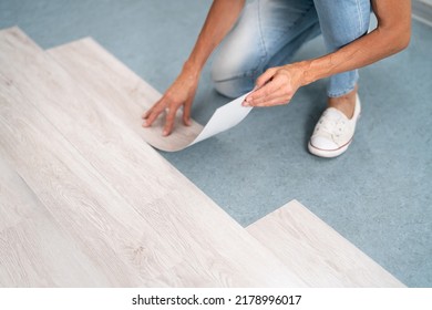 Installing New Vinyl Laminate. Woman Fixing Floor. DIY Project