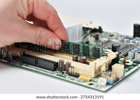 Installing a RAM module into a computer motherboard slot for upgrade or repair