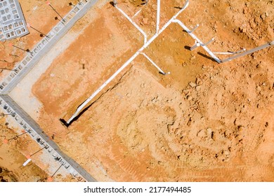 Installing Sewer And Water Pipes In The Ground Under The Foundation Of A New Residential Construction Home An Aerial View