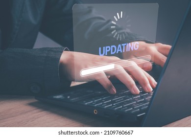 Installing software update process, operating system upgrade concept. Hand using laptop with Installing app patch or app new version updating progress bar on virtual screen. - Shutterstock ID 2109760667