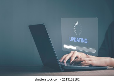 Installing software update process, operating system upgrade concept. Hand using laptop with Installing app patch or app new version updating progress bar on virtual screen.