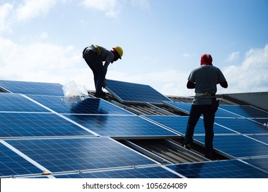 Installing a Solar Cell on a Roof - Shutterstock ID 1056264089