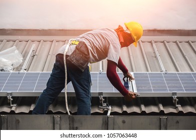 Installing a Solar Cell on a Roof - Shutterstock ID 1057063448