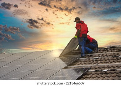 Installing solar photovoltaic panel system. Solar panel technician installing solar panels on roof. Alternative energy ecological concept.
 - Shutterstock ID 2213466509
