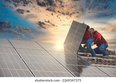 Installing solar photovoltaic panel system. Solar panel technician installing solar panels on roof. Alternative energy ecological concept. - Shutterstock ID 2269347375