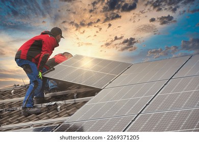 Installing solar photovoltaic panel system. Solar panel technician installing solar panels on roof. Alternative energy ecological concept. - Shutterstock ID 2269371205