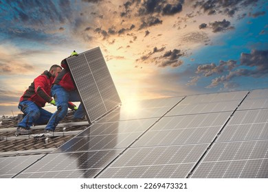 Installing solar photovoltaic panel system. Solar panel technician installing solar panels on roof. Alternative energy ecological concept. - Shutterstock ID 2269473321