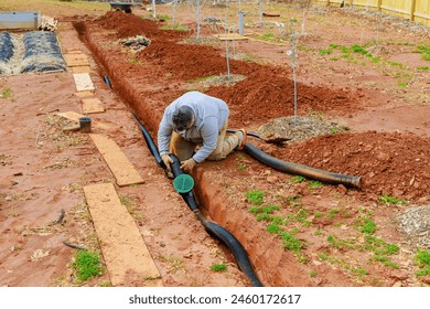 Installing storm drainage drain pipe into trench drain for draining rain water