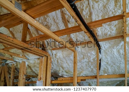 Installing thermal foam polyurea insulation under the roof wool panels and wooden planks