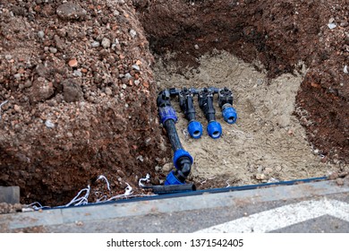 Installing Underground Sprinkler System, Park Automatic Lawn Sprinklers Pipe And Water Valve In A Trench.