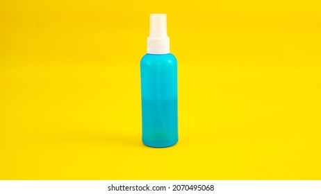 Instant Antiseptic Hand Sanitizer Mist Spray, Antibacterial Alcohol Liquid. One Transparent Plastic Bottle With Atomizer Pump Isolated On Yellow Background, Studio Shot. Mini Travel Pocket Small Size.