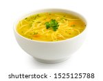 Instant chicken noodle soup in a white ceramic bowl isolated on white. Parsley garnish.