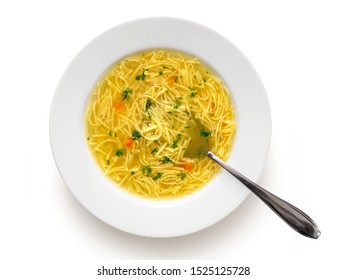 Instant Chicken Noodle Soup In A White Ceramic Soup Plate With Metal Spoon Isolated On White. Top View. Chopped Parsley.