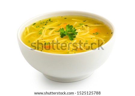 Instant chicken noodle soup in a white ceramic bowl isolated on white. Parsley garnish.