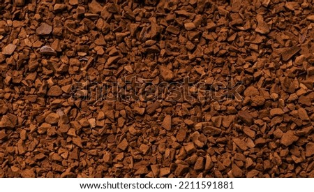 Instant coffee close-up. Background from Soluble coffee granules. Pieces of chocolate. brown background. Granulated brown coffee