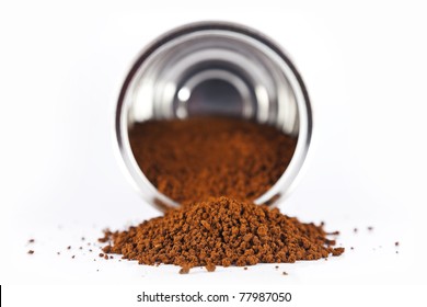 Instant Coffee Poured From A Metal Tin On A White Background.