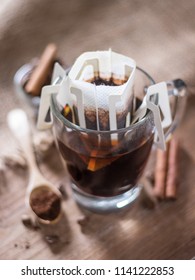 Instant Drip Coffee Using Paper Type Filter With Beans And Cinnamon On Wooden Background