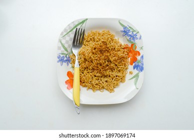 Instant Noodle In The Plate Top Down Photo On White Background.