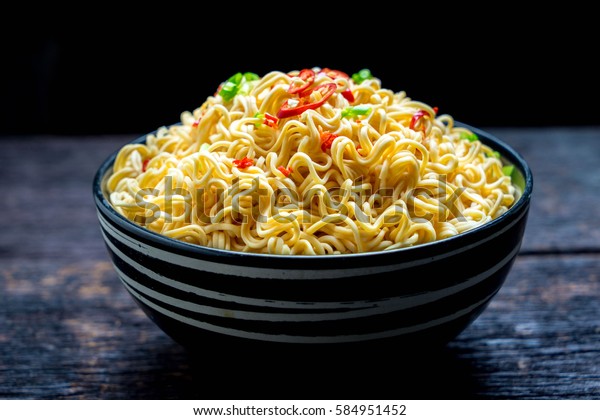 instant noodles\
in the bowl on wooden\
background