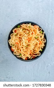 Instant Noodles With Carrot, Scallions, And A Sauce, A Vegetable Soba Bowl, Overhead Shot With Copyspace