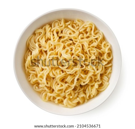 Instant noodles in a plate close-up on a white background. Top view
