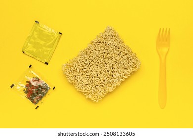 Instant Noodles and Seasoning Packets with Yellow Fork on Vibrant Yellow Background - Powered by Shutterstock