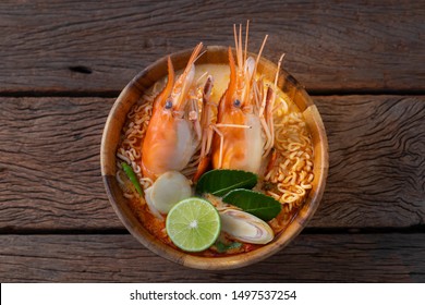 Instant Noodles Shrimp Tom Yum Flavor is the most popular Thai food, served in wooden bowl and place on the table. - Shutterstock ID 1497537254