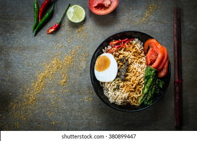 Instant Noodles With Spicy Seasoning, Vegetables And Salted Egg. Top View.