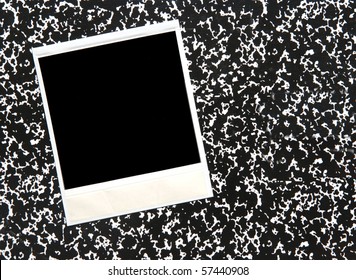instant photograph on a speckled notebook cover