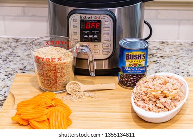 Instant Pot Dinner Preparation With Brown Rice, Carrots Chicken And Black Beans