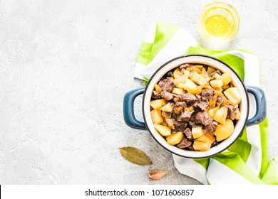 Instant pot meat potato stew on concrete background. Top view, space for text.