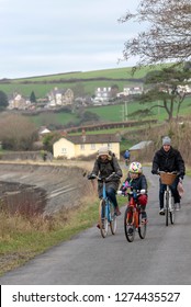 Instow, North Devon, England, UK. January 2019. Family Cycling Along The South West Coastal Path In Winter.