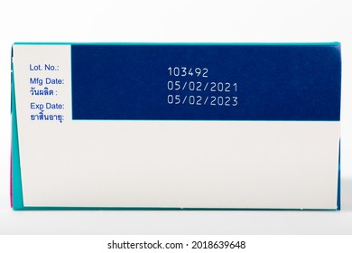 Instruction Of Lot Number, Manufacturing Date, And Expiry Date Label Of A Product With Thai Language On The Bottom Lid Of The Package With Isolated White Background.